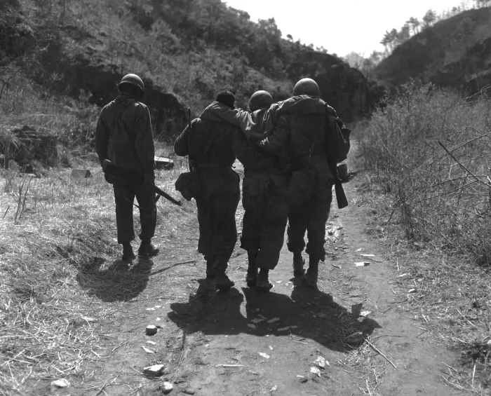Framed Print : U.S. soldiers aid wounded man of 24th Infantry Regiment. Following a battle 10 miles south of Chorwon, in Central Korea, in the UN defense against the Chinese spring Offensive
