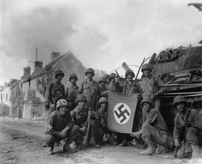 Framed Print : U.S. Soldiers display a captured swastika flag on August 20, 1944. Two days after the Battle of the Falaise Pocket, they were left behind to mop-up in Chambois