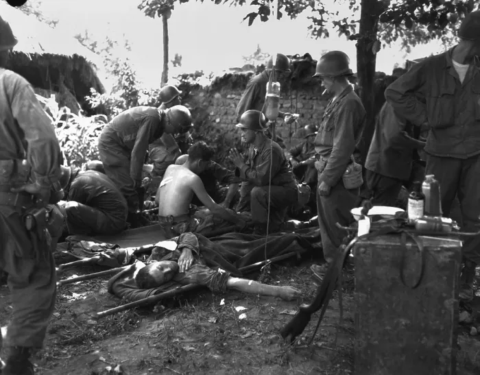 Framed Print : U.S. soldiers receive medical treatment at a first aid station near South Korean battle front. July 25, 1950
