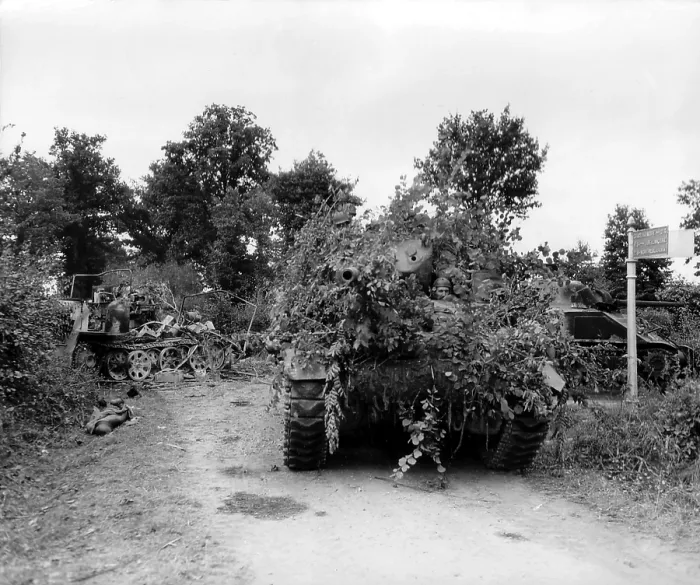 Framed Print : U.S. tanks in combat in the hedgerows of Normandy, during the Battle of the Falaise Pocket. On left is a destroyed German half-track and a dead German soldier Framed Print : U.S. tanks in combat in the hedgerows of Normandy, during the Battle of the Falaise Pocket. On left is a destroyed German half-track and a dead German soldier