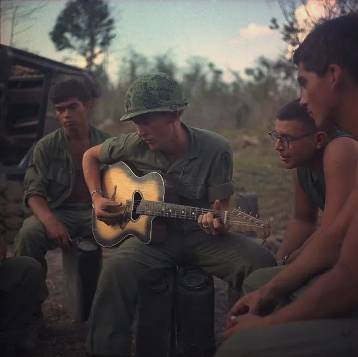 Framed Print : Vietnam War. US Army infantrymen gather around a guitar player and sing a few songs after a hard day during Operation Yellowstone. The operation ran from Dec. 7, 1967 through Feb