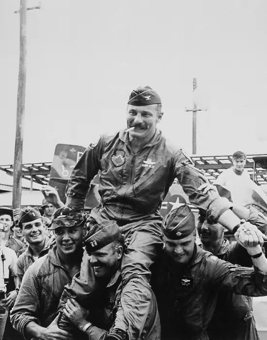 Framed Print : Vietnam War. Colonel Robin Olds (1922-2007) and pilots celebrate the completion his 100th combat mission