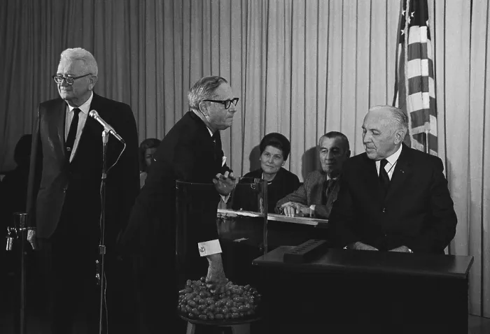 Framed Print : Vietnam War era Selective Service lottery. Congressman Alexander Pirnie pulls lottery capsules. At left is Selective Service Director Lt. General Lewis Blaine Hershey