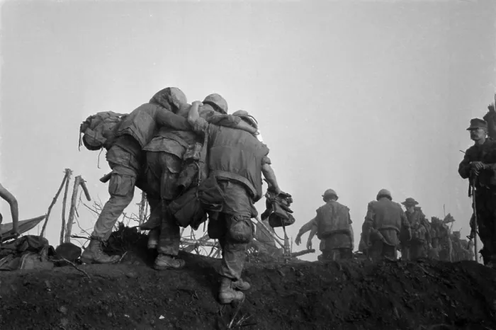 Framed Print : Vietnam War. A US Marine is helped to an evacuation point after he was wounded during Operation Dewey Canyon