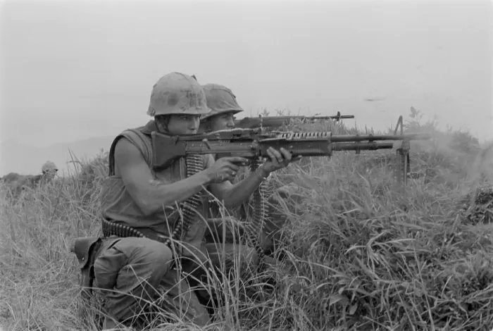 Framed Print : Vietnam War. US Marine machine gunner and rifleman fire at the enemy near the Demilitarized Zone in Vietnam. May 13, 1967