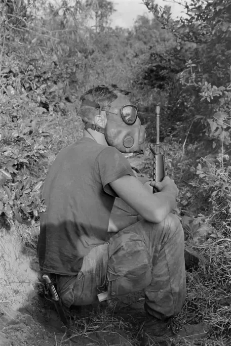 Framed Print : Vietnam War. US Marine wearing gas mask while waiting to enter a Viet Cong tunnel 22 miles south of DaNang, Vietnam. 1968