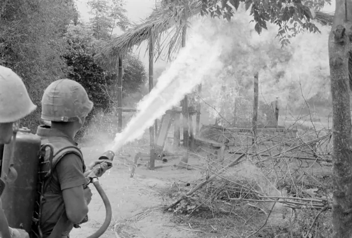 Framed Print : Vietnam War. US Marines set fire to the remains of a building with a flamethrower during a search and destroy mission in Quang Nam Province. March 21-25, 1967