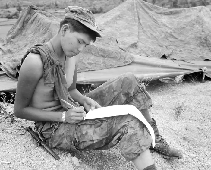 Framed Print : Vietnam War. Private First Class Joseph Big Medicine Jr. a Cheyenne Indian, writes a letter to his family in the United States
