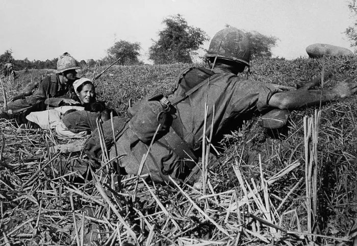 Framed Print : Vietnam War. Soldiers of the 1st Infantry Division protect a refugee mother and her children during a fight with Viet Cong