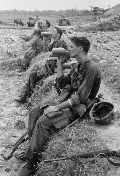 Framed Print : Vietnam War. Soldiers of the 25th Infantry Division drink from their canteens during a break in their patrol operations in Duc Pho, Vietnam. Aug. 31, 1967