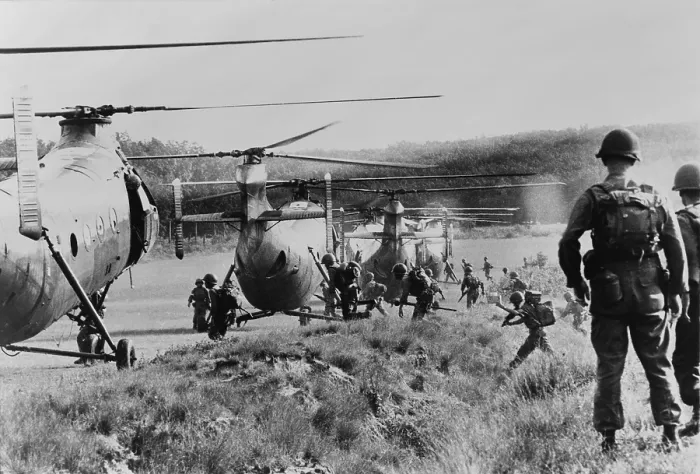 Framed Print : Vietnam War. South Vietnamese troops run to board helicopters for an airborne anti-guerrilla operation in jungles near Saigon, as American advisors watch. 1962
