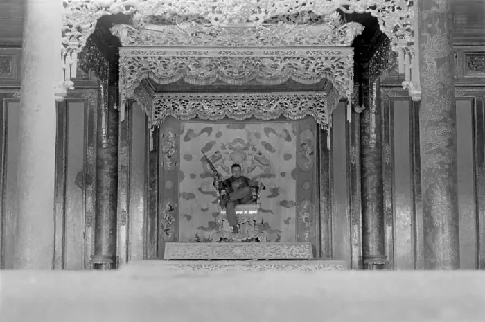 Framed Print : Vietnam War-Tet Offensive. US Marine Sergeant sits on a throne in the palace in the old city of Hue. The Battle of Hue lasted over 30 days. February 24, 1968