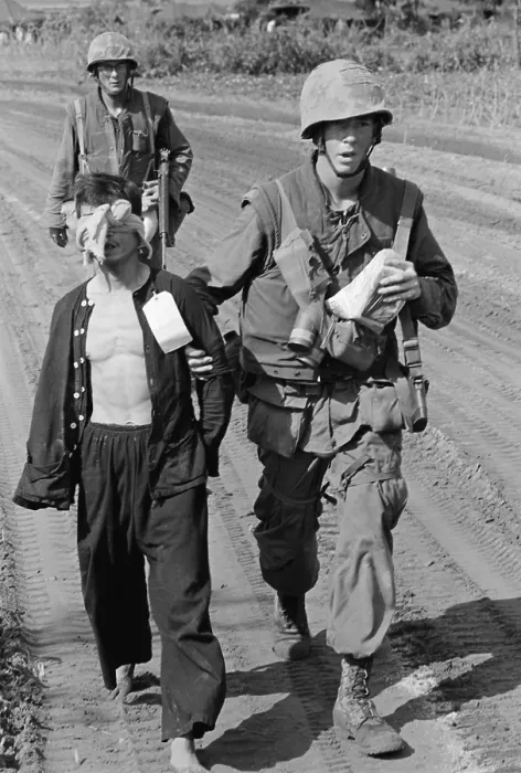 Framed Print : Vietnam War. A Viet Cong prisoner captured during Operation Double Eagle, 20 miles south of Quang Ngai, Vietnam is brought into the collection area by Marines