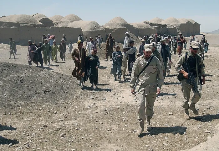 Framed Print : Villagers from Nojoy outside Kandahar International Airport follow the members of the U.S
