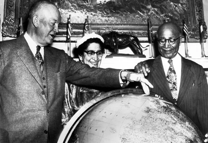 Framed Print : During a visit to the White House, Explorer Matt Henson helps President Eisenhower locate the spot on a globe where he reached the top of the North Pole exactly 45 years before