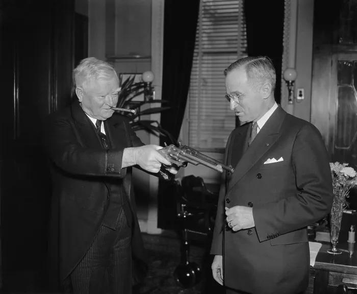 Framed Print : VP James Garner handles 45-caliber pistols as Sen. Harry Truman watches. Feb.17, 1938