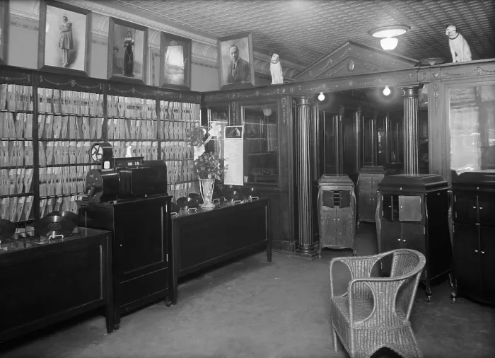 Framed Print : Waldman's Record Shop in New York City ca. 1915-20. The store displays Victrolas, hand cranked record players in wood cabinets which played 78 RPM phonographs