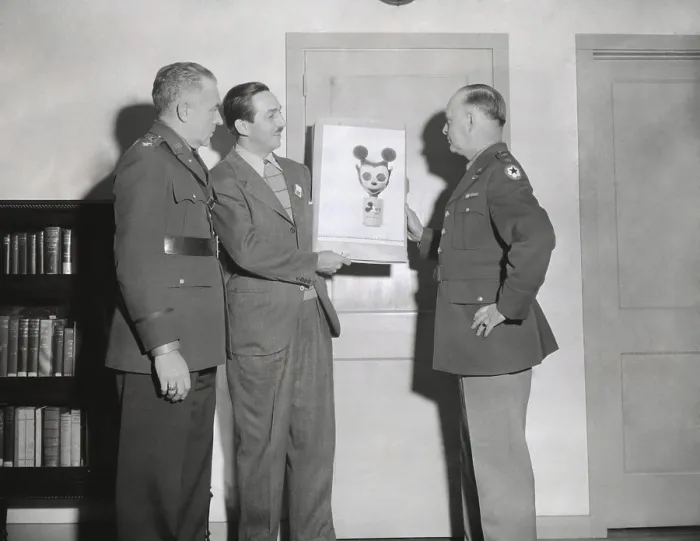 Framed Print : Walt Disney showing a sketch of Mickey Mouse gas mask to Chemical Warfare officer. Gen. William N. Porter, and Civil Defense Chief, Col