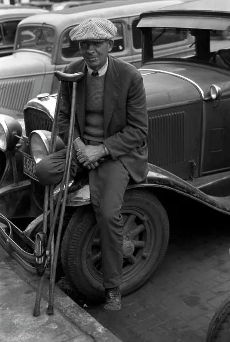 Framed Print : War veteran who sells pencils, a man with an amputated leg with crutches leaning against a car, Omaha, Nebraska, photograph by John Vachon, November, 1938