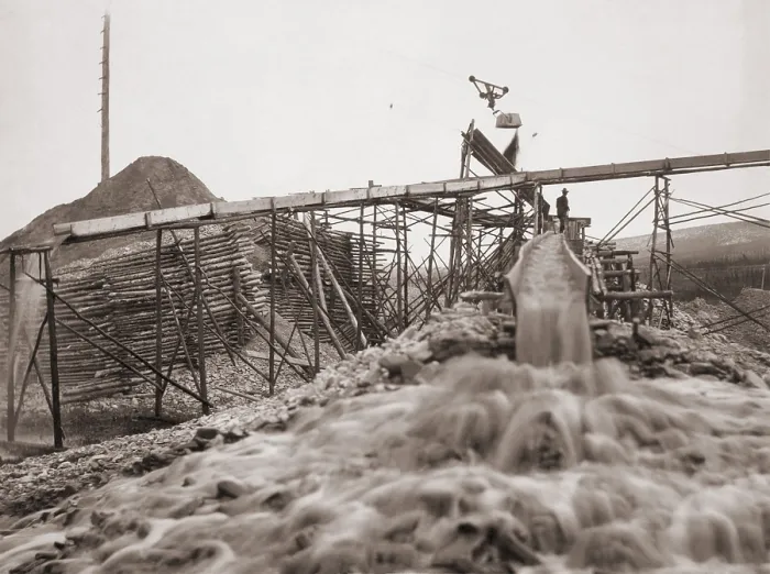 Framed Print : Washing gold in a sluice box placed in the stream to channel water flow