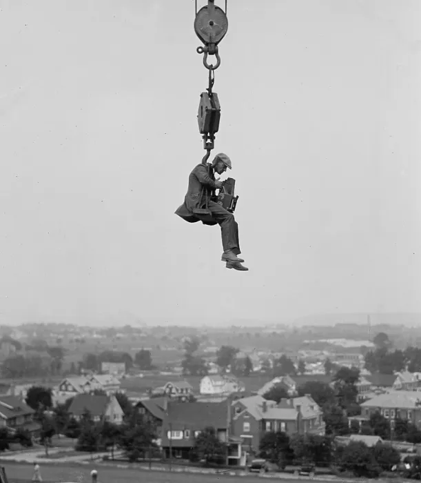 Framed Print : Washington, D.C. photographer hangs from a crane to capture a view of the city in 1923