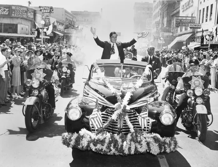 Framed Print : Wendell Willkie accepts the applause of the crowd in Phoenix, Arizona, on Sept. 19, 1940. His flag and flower bedecked convertible is flanked by motorcycle police