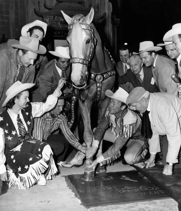 Framed Print : Western film star Roy Rogers (second from right), being honored at Grauman's Chinese Theater along with his horse Trigger, as his wife Dale Evans (foreground left) watches