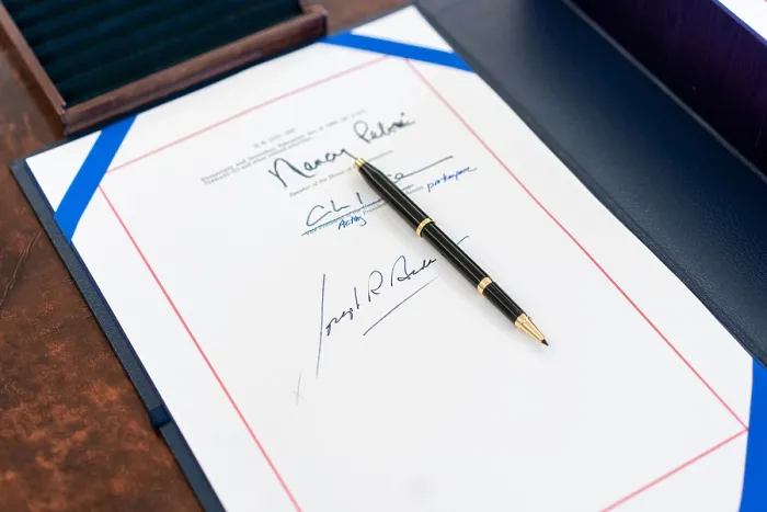 Framed Print : White House staff arranges the signing page and box holding the full text of the American Rescue Plan Act of 2021, on President Joe Biden's Resolute Desk, March 11