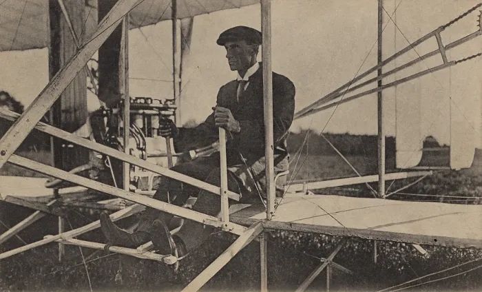 Framed Print : Wilbur Wright sits at the controls of his airplane, c. 1907-1908. He is in the Wright Model A, the first Wright aircraft in which the occupant sat upright (BSLOC_2018_2_148)
