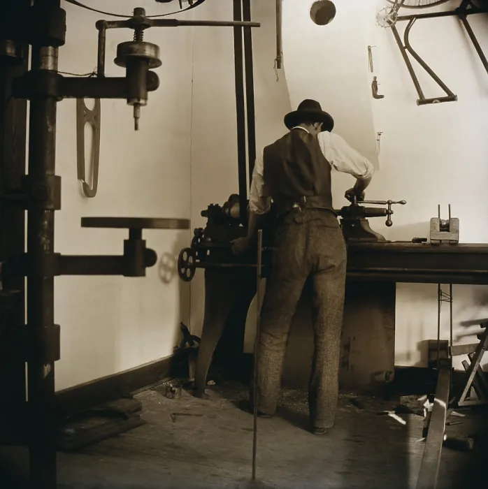 Framed Print : Wilbur Wright works in the bicycle shop at Dayton, Ohio in 1897. The Wright Brothers rented, sold, and manufactured bicycles Framed Print : Wilbur Wright works in the bicycle shop at Dayton, Ohio in 1897. The Wright Brothers rented, sold, and manufactured bicycles