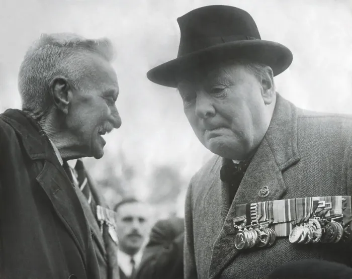 Framed Print : Winston Churchill, wearing his military medals, listening to an elderly man. Ca. 1945 - (BSLOC_2014_17_46)