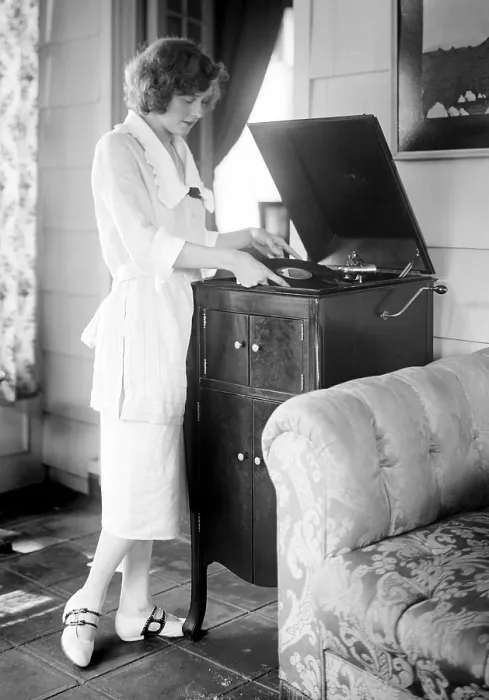 Framed Print : Woman playing a record, circa 1930s
