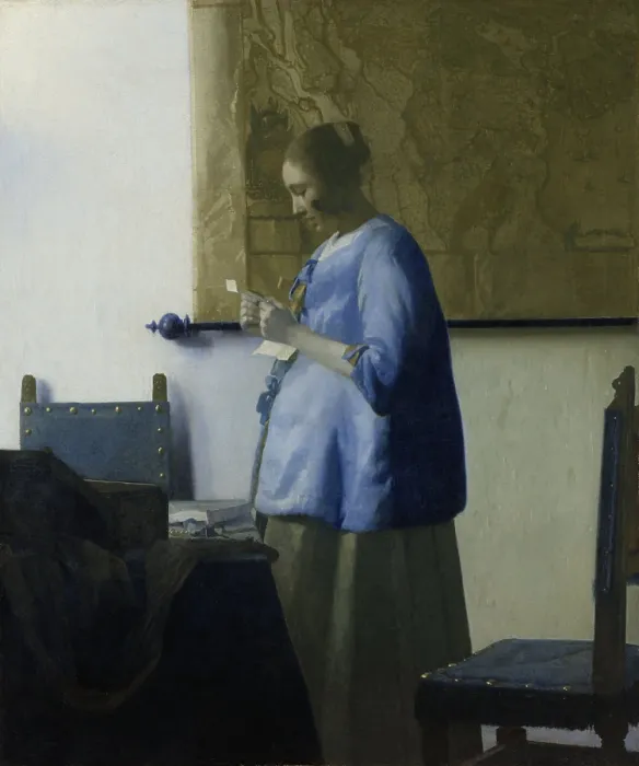 Framed Print : Woman Reading a Letter, by Johannes Vermeer, 1663, Dutch painting, oil on canvas. A young woman in a blue jacket, stands by a table with chairs Framed Print : Woman Reading a Letter, by Johannes Vermeer, 1663, Dutch painting, oil on canvas. A young woman in a blue jacket, stands by a table with chairs