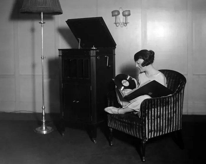 Framed Print : Woman with record albums and victrola, circa 1930s