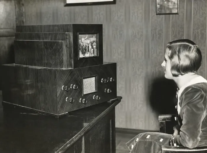 Framed Print : Woman watching a German television with a 14 x 18 centimeter screen. Transmission of live events was still not possible