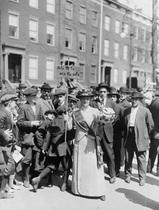 Framed Print : Women identified as Mrs. Suffern, is surrounded by a crowd of men and boys, while she holds a home-made banner in women suffragist parade Help us to win the vote. 1914 Framed Print : Women identified as Mrs. Suffern, is surrounded by a crowd of men and boys, while she holds a home-made banner in women suffragist parade Help us to win the vote. 1914