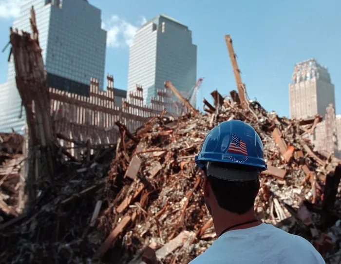 Framed Print : Worker at the pile of rubble from the collapse of WTC 2, the South Tower on Oct. 3, 2001. The ruins of the Twin Towers formed 15 meters high piles