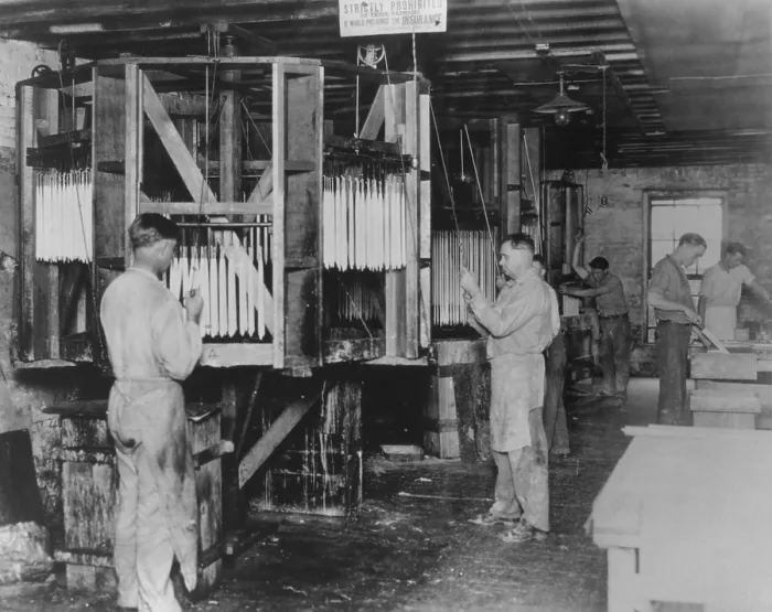 Framed Print : Workman hand dipping candles at the St. Louis Candle and Wax Company, 1927. Candle making was a declining industry as Americans gained access to electric lights (BSLOC_2016_8_52)