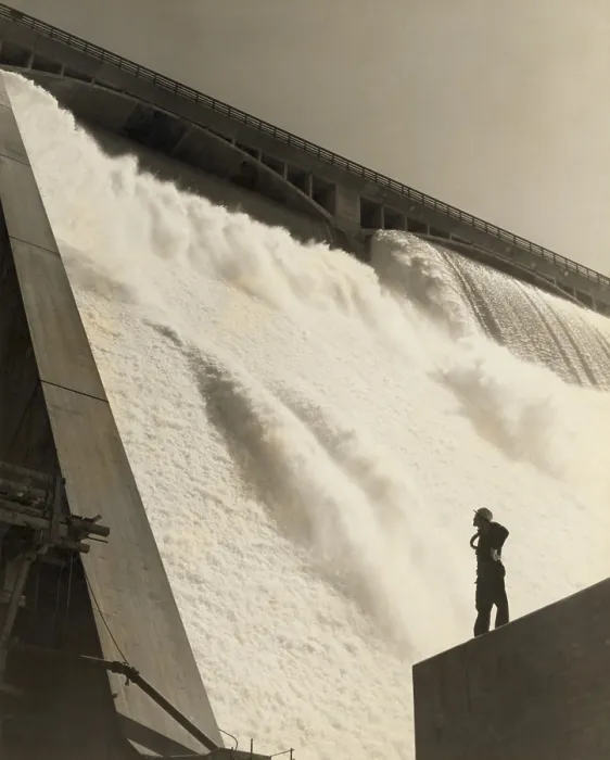 Framed Print : A workman inspecting the Grand Coulee Dam from the partially-complete wall near the east powerhouse, July 20, 1942. (BSLOC_2013_8_19)
