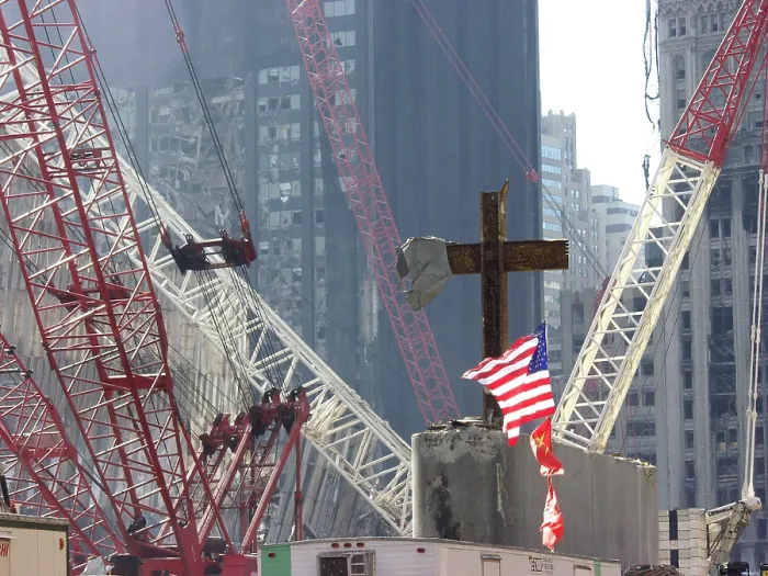 Framed Print : At the World Trade Center disaster site workers use heavy machinery to remove one of the steel beams from the section dubbed God's House in reference to the many