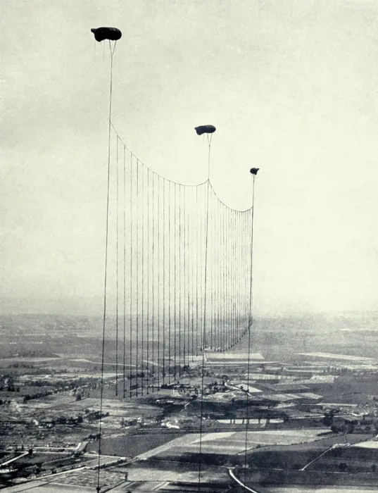 Framed Print : World War 1. British Barrage balloons dangle metal cables, to disable low-level German aircraft on night bombing missions over England. 1915-18. (BSLOC_2013_1_83)