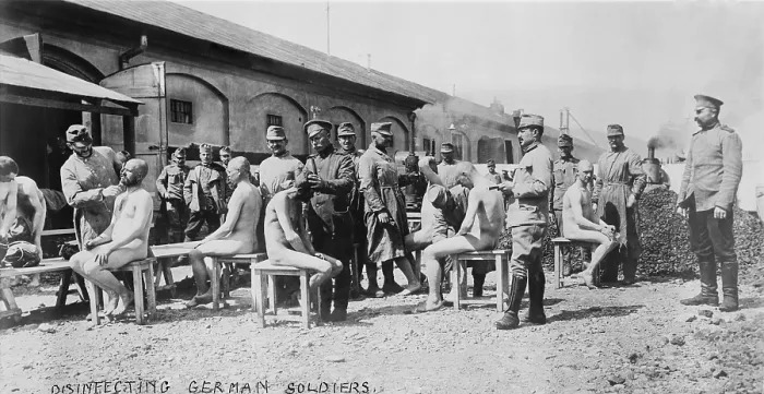 Framed Print : World War 1. Disinfecting German soldiers. Soldiers in French uniforms shave hair from German POWs to prevent lice borne disease. Ca. 1914-18