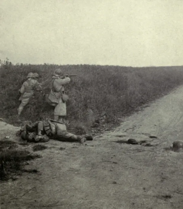 Framed Print : World War 1. French soldier firing at the enemy through the wheat fields southeast of Amiens. The dead German soldier was killed when the first wave of the attack as repulsed