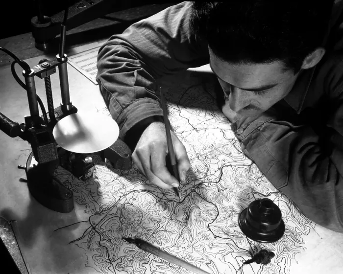 Framed Print : World War 2 Strategic planning for the invasion of Europe. U.S. Army map maker inking in the pencil tracings of culture, hydrography, and land contours. England, Jan. 11, 1943