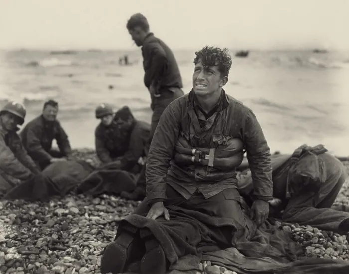 Framed Print : World War II. American soldiers on Omaha Beach recovering the dead after the D-Day invasion of France. June 1944, by U.S. Army Signal Corps photographer, Walter Roseblum