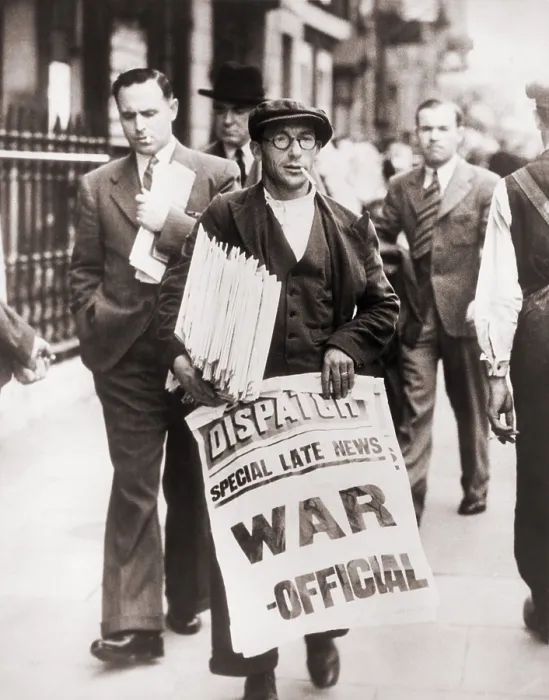 Framed Print : World War II. Announcing state of war with Germany, a British Newspaper man holding stack of newspapers and sign stating Special late news: War - Official, in Whitehall