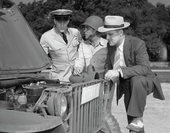 Framed Print : World War II, George Woolslayer (right) examining an army jeep at the post where Sergeant French L