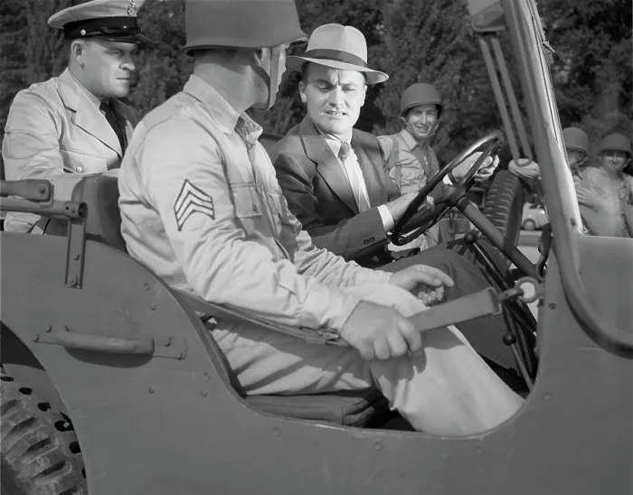 Framed Print : World War II, George Woolslayer (right) examining an army jeep at the post where Sergeant French L
