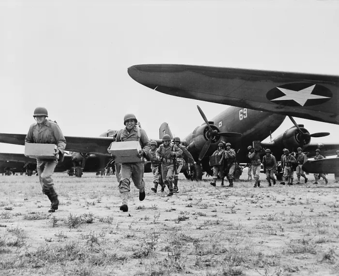 Framed Print : World War II, landing operation of U.S. Airborne infantry force in the southwestern United States. The troops unloading supplies and ammunition from transport planes, circa 1942