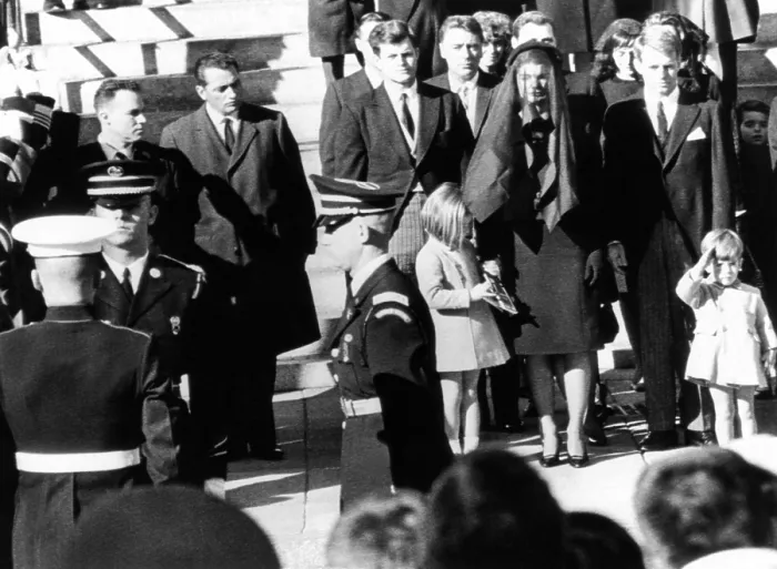 Framed Print : Three year old John F. Kennedy Jr. salutes his father's flag draped coffin after funeral mass at St. Matthew's Cathedral. Family members from center, L_R: Sen